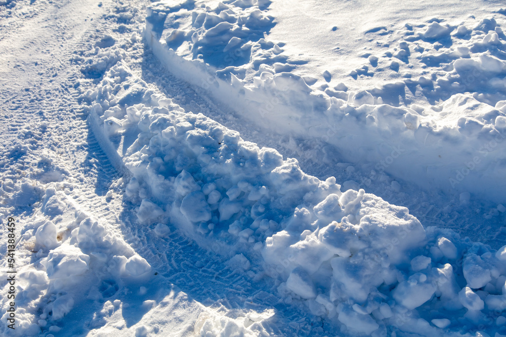 Wall mural road in the snow in winter as a background.