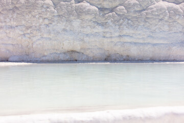 Emerald water in white limestone rock.