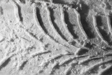 Traces from a car in winter as a background.