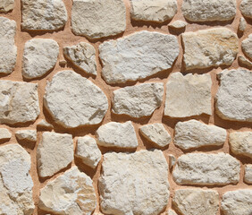 Ancient brick wall made of stone as an abstract background.