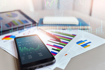 Double explosure with business chart, business people use technology from mobile and tablet computer with chart on screen to analysis investment plan