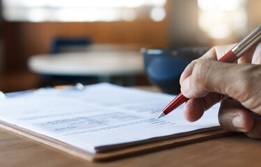 A businessman make an appointment to sign a business contract in a coffee shop to start a new...