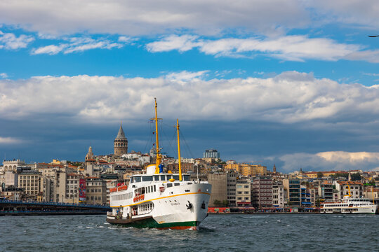 Ferry and Galata Tower with cloudy sky. Travel to Istanbul