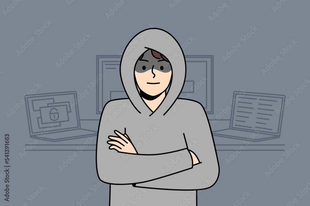 Poster young man in hood standing near computers hacking internal operations system. suspicious male hacker