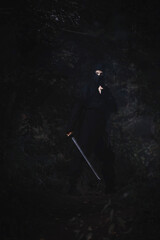 Ninja silent killer waits in ambush in forest undergrowth
