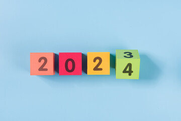 Flipping wooden cubes for new year change 202 to 2024. New year change and starting concept.