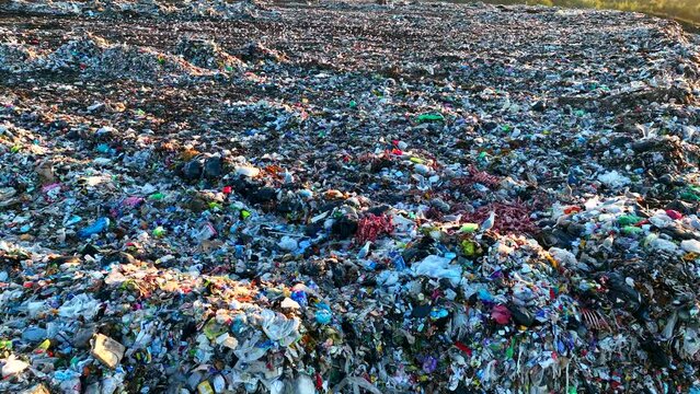 Seagulls at Garbage dump. Sea birds eat trash waste and rotten meat at landfill. Garbage dump with plastic waste. Seagull fly on landfill, aerial view. Landfill with rubbish, garbage, drone view. 