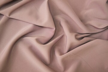 The texture of the fabric is cream-colored. Textile industry for the creation of clothing.