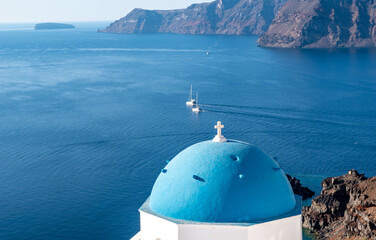 Blue-domed Greek Orthodox church at Oia town on Santorini island