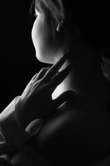 Beautiful girl in the dark, black and white photo. Vertical Orientation