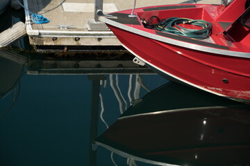 Reflection of red sport boat docked at Edmonds marina