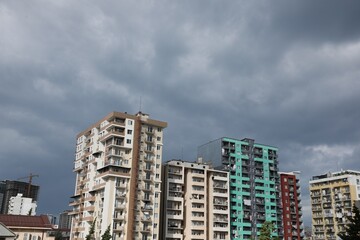 Fototapeta na wymiar Beautiful view of multi storey apartment buildings under gloomy sky