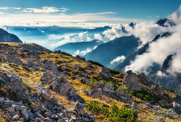 Highland landscape with peaks above the clouds. Beautiful view with big rocks and mountains in...