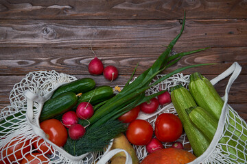 Healthy food vegetables in Eco-friendly packaging reusable bag on wooden table background.