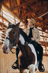 Handsome cowboy man riding a horse on a ranch.