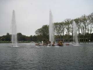 Scenic view with fountain in the park on a cloudy autumn day. People like healthy lifestyle and...