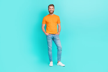 Fototapeta na wymiar Full body photo of kind beard guy stand wear t-shirt jeans sneakers isolated on turquoise color backgroiund
