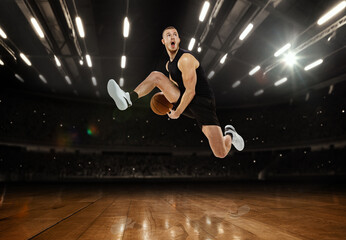 High jump. Young professional basketball player playing basketball at basketball court with people fans. Photoreal 3d render of sport arena.