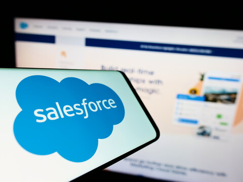Stuttgart, Germany - 10-21-2022: Cellphone with logo of American software company Salesforce Inc. on screen in front of website. Focus on center-right of phone display.