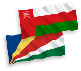 National vector fabric wave flags of Sultanate of Oman and Seychelles isolated on white background. 1 to 2 proportion.