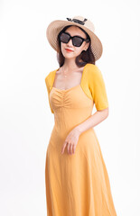 A woman in a yellow dress with a hat and sunglasses
