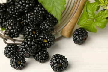 Fresh ripe blackberries on white wooden table, closeup