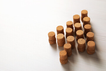 Christmas tree made of wine corks on white wooden table. Space for text