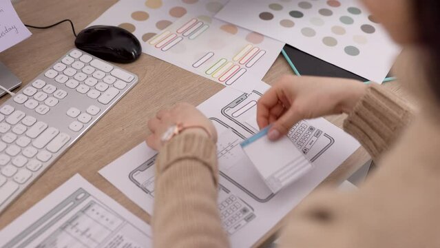 Phone, app and design with the hands of a woman in business working on software development in her office. Planning, creative and strategy with a female employee at work on a smartphone application