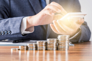 A pile of coins lined up in front of the merchant