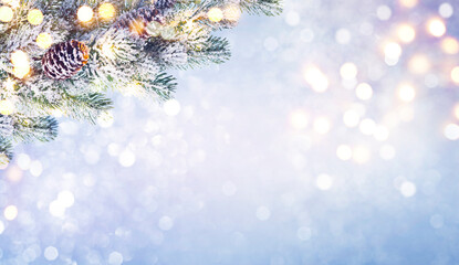 Abstract frosty Christmas lights background with decorated fir tree branch