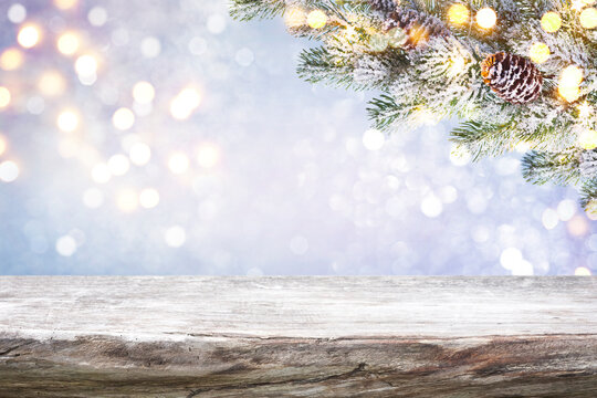 Rough wooden table top with abstract frosty Christmas lights background