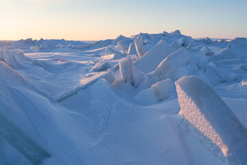 Winter arctic landscape. View of large ice hummocks and snowdrifts. Snow-covered ice floes on the...