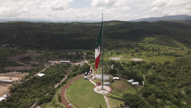 Aerial orbit view around Mexican flag for Independence Declaration in Iguala