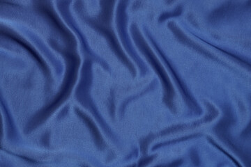 Smooth blue texture of blue silk or satin fabric can be used as an abstract background.
