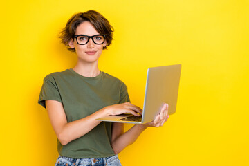 Photo of smart intelligent girl with bob hairstyle wear khaki t-shirt hold laptop writing email...