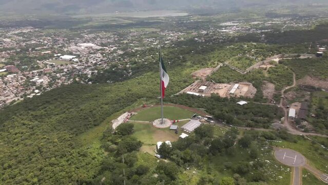 Flying around Mexican Independence flag over the mountains of Iguala in Guerrero