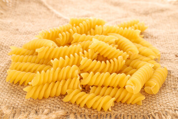 Durum wheat pasta  on a jute napkin, macro.