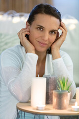 young beautiful woman meditating at home smiling