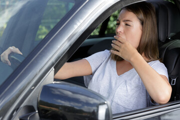 a woman yawning while driving