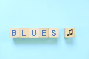 Blues music genre or style concept. Creative flat lay typography composition in blue background.