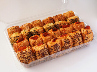 Mini salty tuna pies in a plastic food container