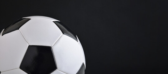 Detail of classic leather stitched soccer ball dark isolated
