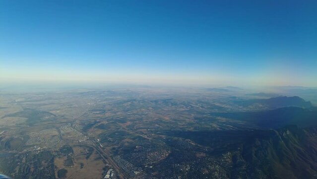 Flying over mountains inside the plane aerial footage.