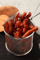 Sweet potato fries on wooden board, closeup