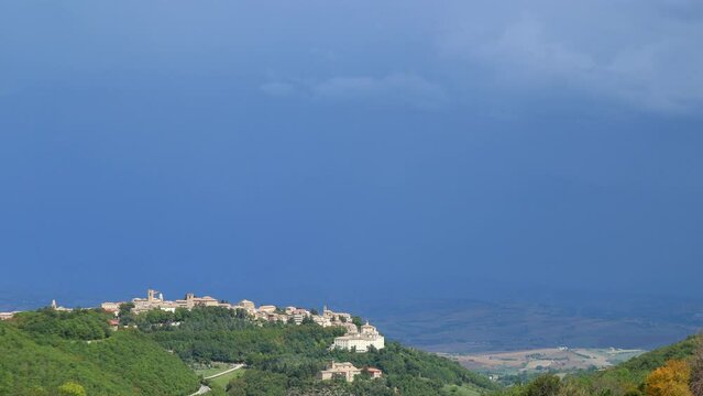 the sky changes rapidly and becomes dark over an ancient Italian town