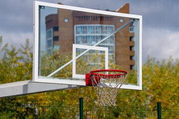 Basketball backboard with a red basket for the ball.