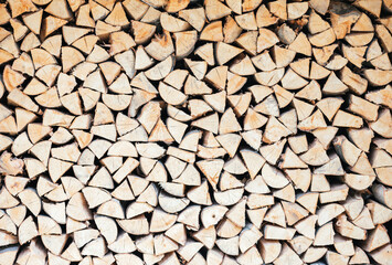 Stacked firewood for the harsh winter. The energy crisis is multiplying the demand for firewood as a source of heat. Concept of energy crisis and savings.