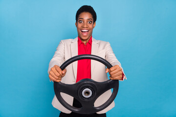Photo of crazy positive person hold wheel have fun drive fast new car isolated on blue color background