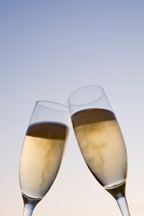 Scene of toasting with two champagne glasses filled with champagne