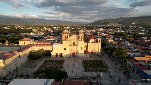 backwards drone shot of santo domingo temple in downtown oaxaca city in mexico during sunset